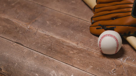 Close-Up-Studio-Baseball-Still-Life-With-Wooden-Bat-And-Ball-In-Catchers-Mitt-On-Wooden-Floor-5